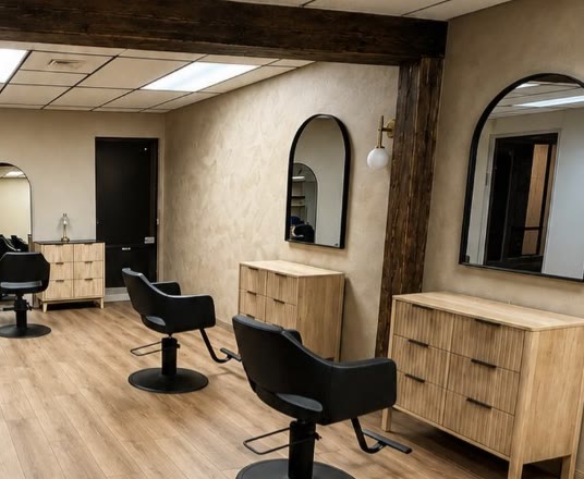 Inside Girl Talk Salon: arched mirrors over oak stations